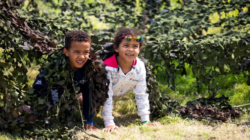 Children crawling through a cameo net